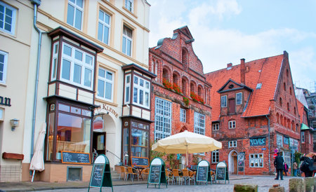 LUNEBURG, GERMANY - NOVEMBER 20, 2019: The scenic medieval houses of Altstadt with cozy cafesa and shops, on Nov 20 in Luneburg, Germanyのeditorial素材