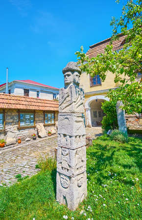 The ancient carved Pagan Idol on the lawn of the tiny garden of Archaeological Museum, Kamianets-Podilskyi, Ukraineの写真素材