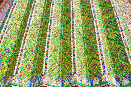 Ceramic tiles with floral patterns on the wall of Clock Tower in Grand Palace, in Bangkok, Thailand