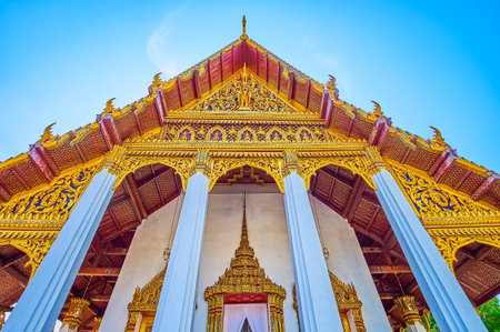 BANGKOK, THAILAND - MAY 12, 2019: The golden carved pediment and the roof of The Ho Phra Monthiantham temple in Grand Palace, on May 12 in Bangkok, Thailandのeditorial素材