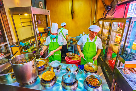 BANGKOK, THAILAND - MAY 12, 2019: The cooks prepares food in the the kitchen of Chinese restaurant in Chinatown, on May 12 in Bangkokのeditorial素材