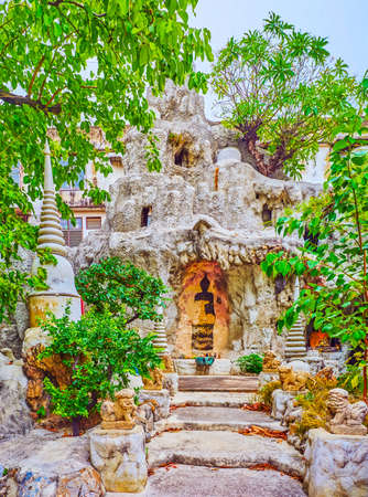 The small buddhist shrine with Altar carved in a rock, Wat Chakkrawat Temple complex in Bangkok, Thailandの写真素材