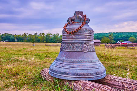 The bronze bell at St Nicholas church decorated with patterns and relief images of Virgin Mary, Cossack Village Scensen, Ukraineの写真素材