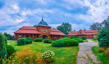 The evening walk in courtyard of Bohdan Khmelnytsky Residence among restored wooden buildings, Chyhyryn, Ukraineの写真素材
