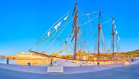 The scenic wooden sail ship, moored in Malaga Port in front of the modern cruise liner, Spainの写真素材