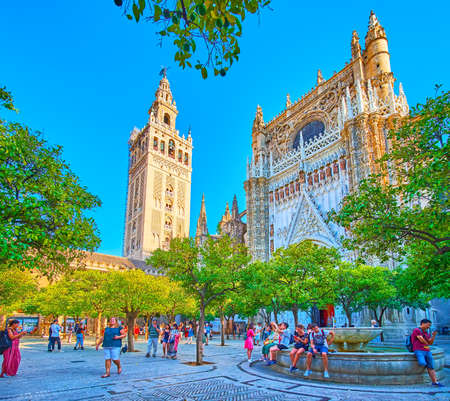 SEVILLE, SPAIN - OCTOBER 2, 2019: Relax in the shade of trees in Orange Trees Garden of Seville...