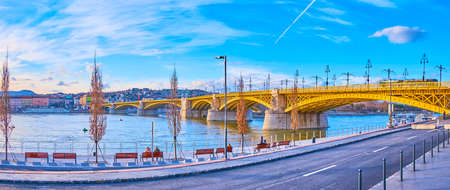 Enjoy the panorama of Danube River, Margaret Bridge and bright blue sky with contrails from the Jozsef Antall embankment, Pest district, Budapest, Hungaryの写真素材