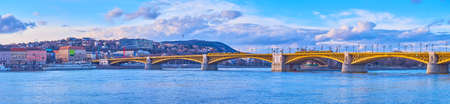 Panorama of the vintage Margaret Bridge with bright yellow metal sections and the azure surface of Danube River, Budapest, Hungaryの写真素材