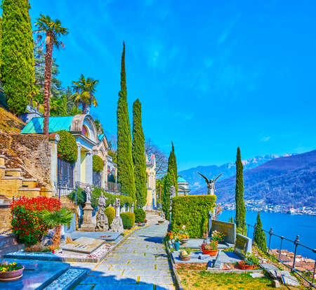 MORCOTE, SWITZERLAND - MARCH 25, 2022: The alley of Monumental Cemetery, located on the mountain slope, observing Lake Lugano, on March 25 in Morcote, Switzerlandの写真素材