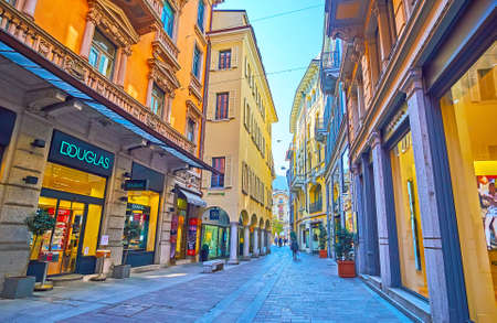 LUGANO, SWITZERLAND - MARCH 25, 2022: The  narrow Via Nassa in the old town with stores and boutiques in historic houses, on March 25 in Luganoのeditorial素材