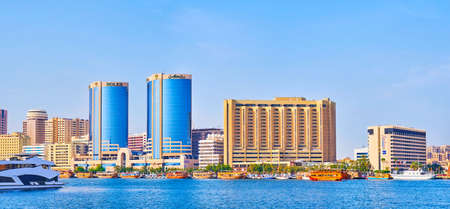 DUBAI, UAE - MARCH 1, 2020: Panorama of Dubai Creek with modern Deira architecture and famous Twin Towers (Rolex Towers), on March 1 in Dubaiのeditorial素材