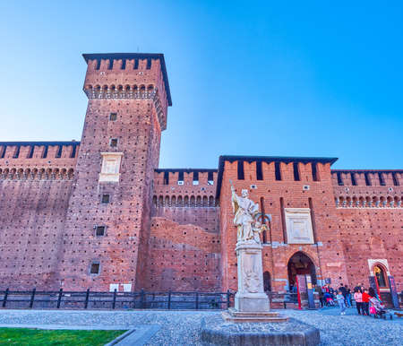 MILAN, ITALY - APRIL 5, 2022: The statue of San Giovanni Nepomuceno and the walls of Sforza Castle with Bona di Savoia tower, on April 5 in Milan, Italyのeditorial素材