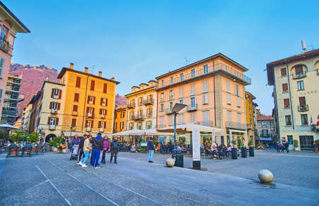 COMO, ITALY - MARCH 20, 2022: Alessandro Volta Square in old town with historic houses, cafes and...