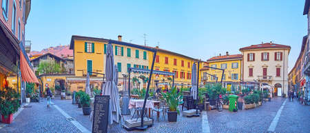 COMO, ITALY - MARCH 20, 2022: Panorama of Piazza Giuseppe Mazzini with outdoor restaurants,...