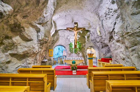 BUDAPEST, HUNGARY - FEB 27, 2022: The Cross on altar in Gellert Hill Cave Church (Rock Church of Our Lady of Hungary), on Feb 27 in Budapestのeditorial素材