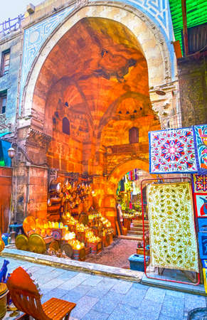 The medieval Bab al-Ghuri gates with colorful dome and inner lighting shop hidden in a maze of narrow streets of Khan EL-Khalili market, Cairo, Egyptの写真素材