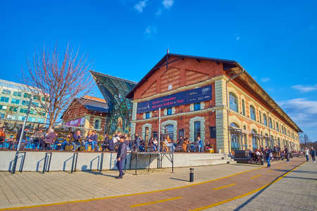 BUDAPEST, HUNGARY - FEB 27, 2022: The crowded outdoor terrace of the restaurant of Balna (Whale) cultural, commercial and trade center, located on Fovam Square, on Feb 27 in Budapestのeditorial素材