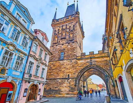 PRAGUE, CAZECH REPUBLIC - MARCH 6, 2022: The Mostecka Street with colored historic townhouses opens the view on Mala Strana Bridge Tower of Charles Bridge, on March 6 in Pragueのeditorial素材