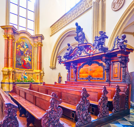 BRNO, CZECH REPUBLIC - MARCH 10, 2022: The scenic wooden carved benches in St James Church, on March 10 in Brno, Czech Republicのeditorial素材