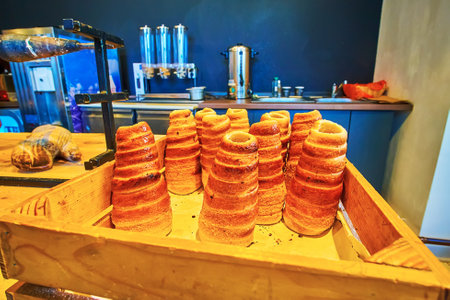 The wooden tray with fresh baked Bohemian trdelnik pastry in a small cafe of Mala Strana neighborhood, Prague, Czech Republicのeditorial素材
