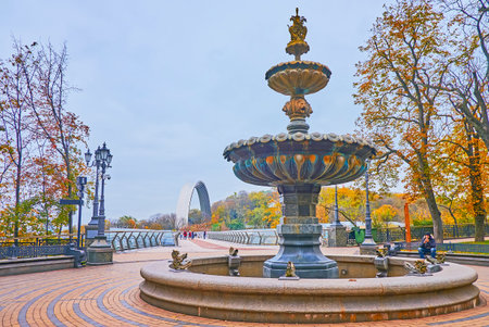 KYIV, UKRAINE - NOV 9, 2022: Historic Termen Fountain in St Volodymyr Hill park in front of Glass Bridge and Arch of Freedom, on Nov 9 in Kyivのeditorial素材