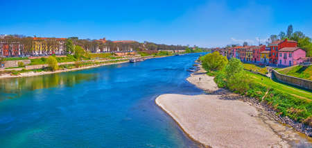 Panorama of narrow Ticino river and small residential houses on its banks in Pavia city, Italy