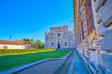 The courtyard of Certosa di Pavia monastery with scenic facade of Cathedral, Italy