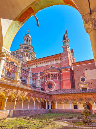 The view on the Cathedral of Cartosa di Pavia monastery complex from the arch of small cloister,...