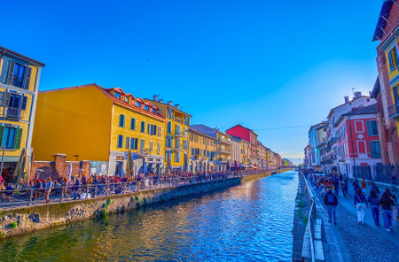 MILAN, ITALY - APRIL 9, 2022:  Evening time on Naviglio Grande Canal, the popilar spot among locals, on April 9 in Milan, Italyのeditorial素材