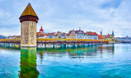 LUCERNE, SWITZERLAND - MARCH 30, 2022: Stunning Wasserturm, the remains of medieval fortification system of Reuss River, on March 30 in Lucerne, Switzerlandの写真素材