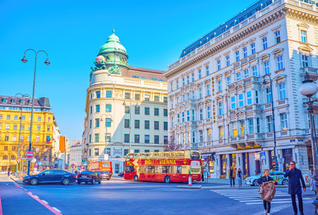 VIENNA, AUSTRIA - FEBRUARY 17, 2019: Walk Traffic on Albertinaplatz Square with historic building of former Riunione Adriatica di Sicurta insurance company, on February 17 in Vienna, Austriaのeditorial素材