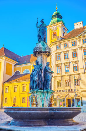 VIENNA, AUSTRIA - FEBRUARY 17, 2019: Historical Austriabrunnen (Austria Fountain) with scenic sculptures on Freyungplatz square, on February 17 in Vienna, Austriaのeditorial素材
