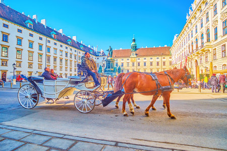 VIENNA, AUSTRIA - FEBRUARY 17, 2019: THe tourist horse-drawn carriage in Inner Burgplatz square of Hofburg, on February 17 in Vienna, Austriaのeditorial素材