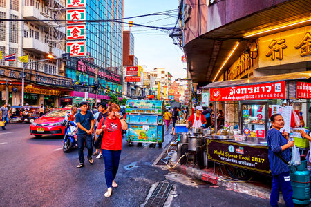 BANGKOK, THAILAND - APRIL 23, 2019: Crowded Yaowarat Road during Chinatown's night market with outdoor food stalls and carts, on April 23 in Bangkok, Thailandのeditorial素材