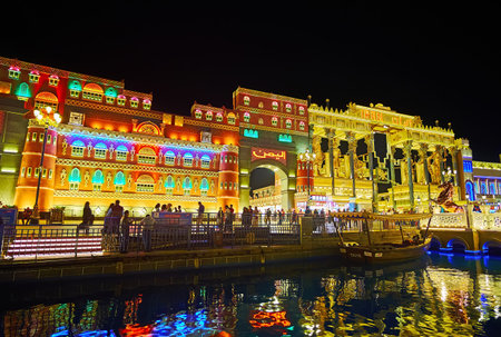 DUBAI, UAE - MARCH 6, 2020: Beautiful illuminated pavilions of  Global Village Dubai seen behind the...