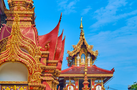 Traditional Lanna roof decorations of temple buildings in Wat Saen Muang Ma, Chiang Mai, Thailandの写真素材