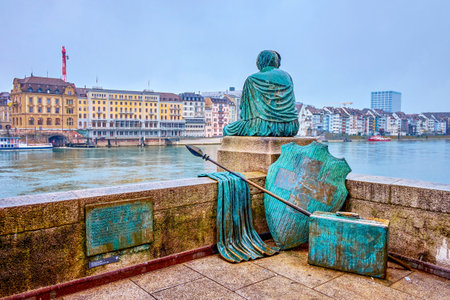 BASEL, SWITZERLAND - APRIL 1, 2022: The modern sculpture Helvetia auf der Reise on Mittlere Brucke bridge, on April 1 in Basel, Switzerlandのeditorial素材