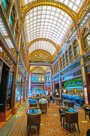 BUDAPEST, HUNGARY - FEB 22, 2022: The beautiful interior of the luxury restaurant in Paris Court (Brudern House) with stained-glass vault and carved wood, on Feb 22 in Budapestのeditorial素材