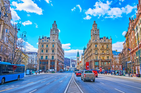 BUDAPEST, HUNGARY - FEB 22, 2022: Lajos Kossuth Street with a view on iconic Clotilde Palaces and fast traffic on the road, on Feb 22 in Budapestのeditorial素材