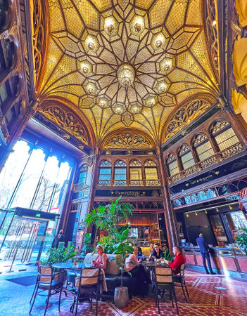 BUDAPEST, HUNGARY - FEB 22, 2022: The splendid interior of Parisi Passage Cafe and Brasserie with ornate glass dome and wooden decorations, on Feb 22 in Budapestのeditorial素材