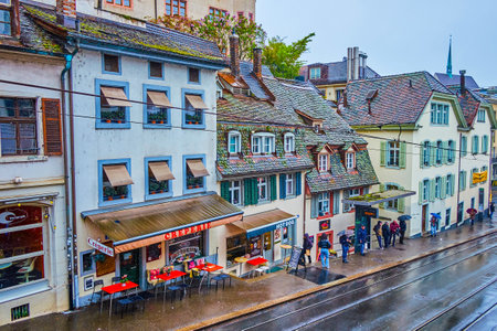 BASEL, SWITZERLAND - APRIL 1, 2022: Restaurants on Kohlenberg street in old town, Switzerland