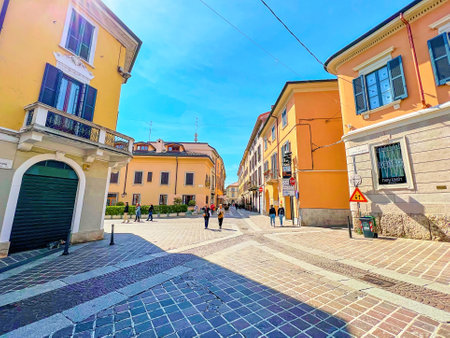 MONZA, ITALY - APRIL 11, 2022: Walk along narrow Via Carlo Alberto street passing small townhouses of medieval town, on April 11 in Monza, Italyのeditorial素材