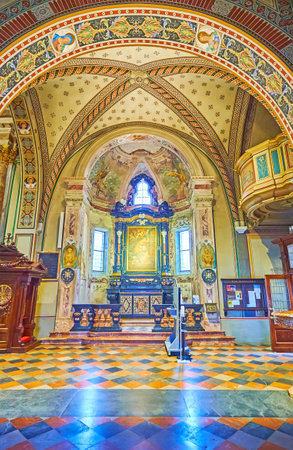 LUGANO, SWITZERLAND - MARCH 14, 2022: The richly decorated frescoed side chapel in San Lorenzo Cathedral, Lugano, Switzerlandのeditorial素材