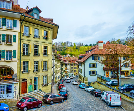 BERN, SWITZERLAND - MARCH 31, 2022: Scenic curved Nydeggstalden street with charmind houses, on...