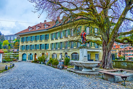 BERN, SWITZERLAND - MARCH 31, 2022: Lauferplatz square with one of the typical Bernese fountains with colorful sculptures, on March 31 in Bern, Switzerlandのeditorial素材