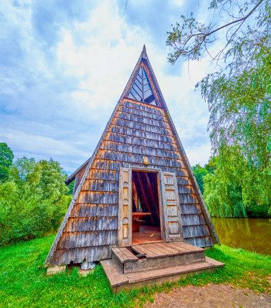 The small vintage hunter's house on the lake, surrounded with lush green forest, Styr hunting farm, Zbrui village, Lviv Region, Ukraineの写真素材