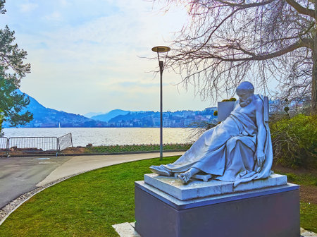 LUGANO, SWITZERLAND - MARCH 13, 2022: The statue of dying Socrates in Parco Ciani on Ceresio bank, on March 13 in Luganoのeditorial素材
