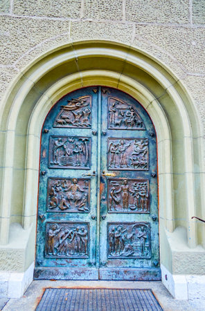 The bronze wrought iron door of Nydeggkirche church with the scenes from the Holy Bible, Bern, Switzerlandのeditorial素材