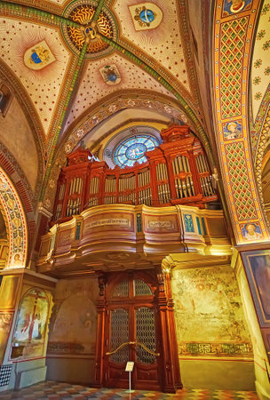 LUGANO, SWITZERLAND - MARCH 14, 2022: The carved wooden pipe organ and fine frescoes in San Lorenzo Cathedral, Lugano, Switzerlandのeditorial素材