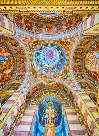CHERNIVTSI, UKRAINE - JULY 16, 2021: The ornate decorations of dome, vault and walls of the Seminary Three Saints Church of Chernivtsi National University, on July 16 in Chernivtsiのeditorial素材